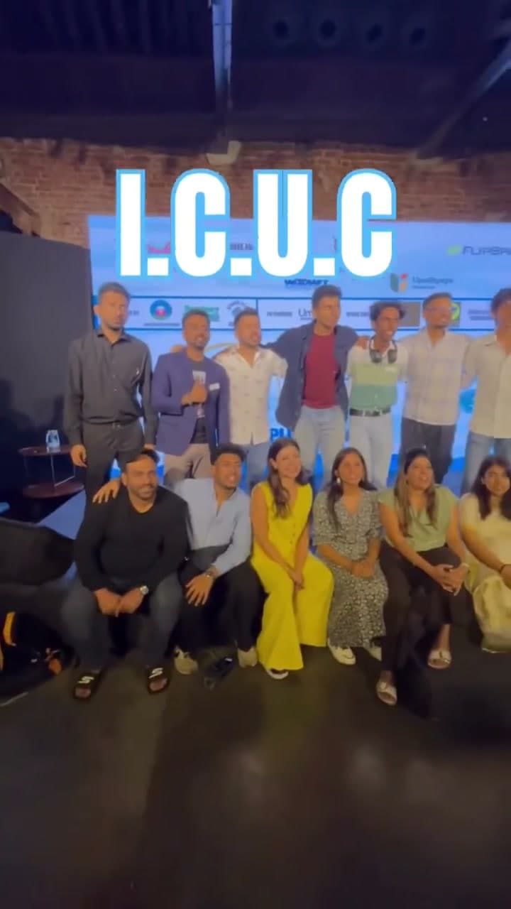 The ICUC 2.0 team gathered on stage in front of the sponsor backdrop