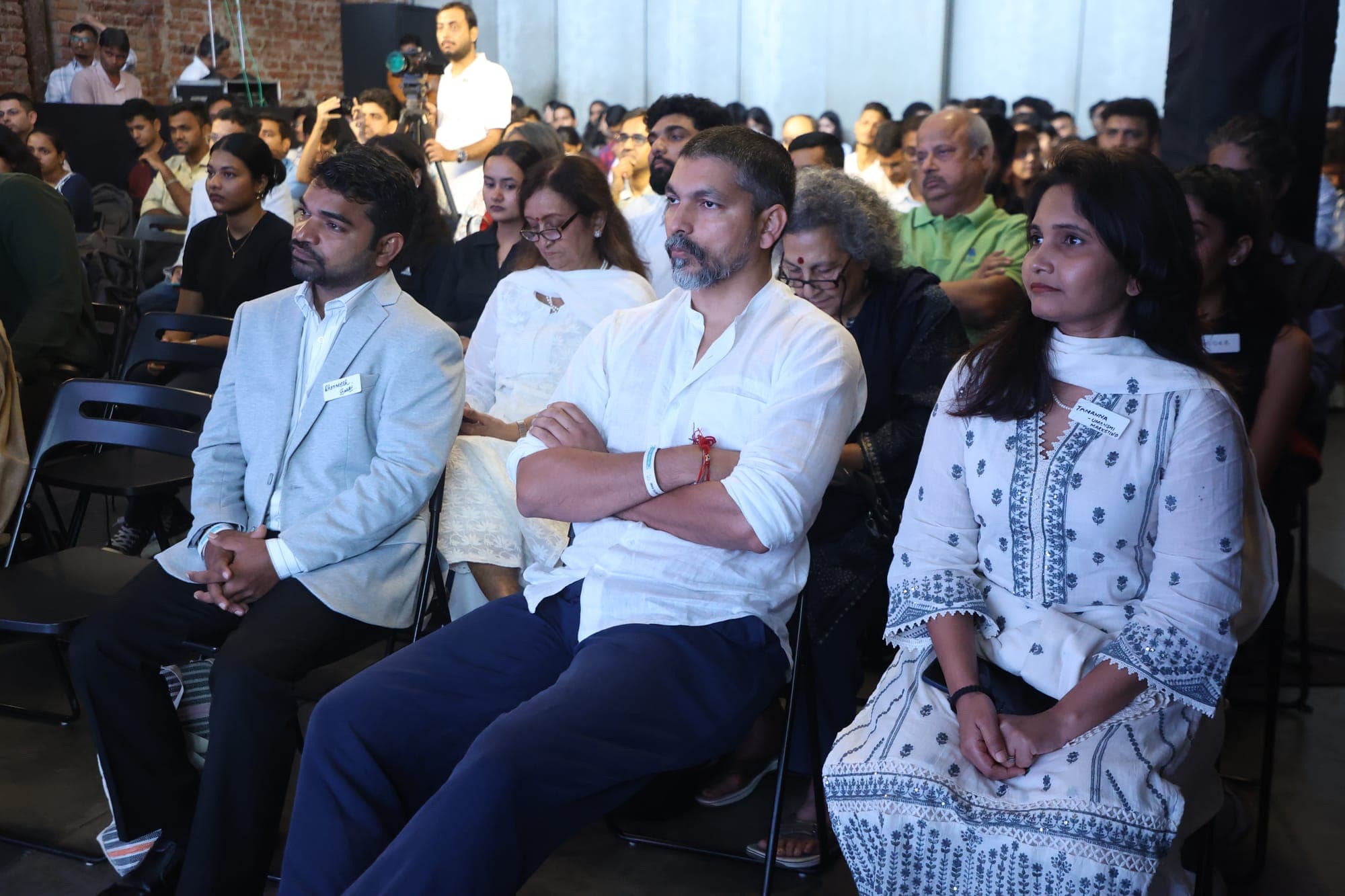 Delegates seated in the front rows of the audience, listening to a session