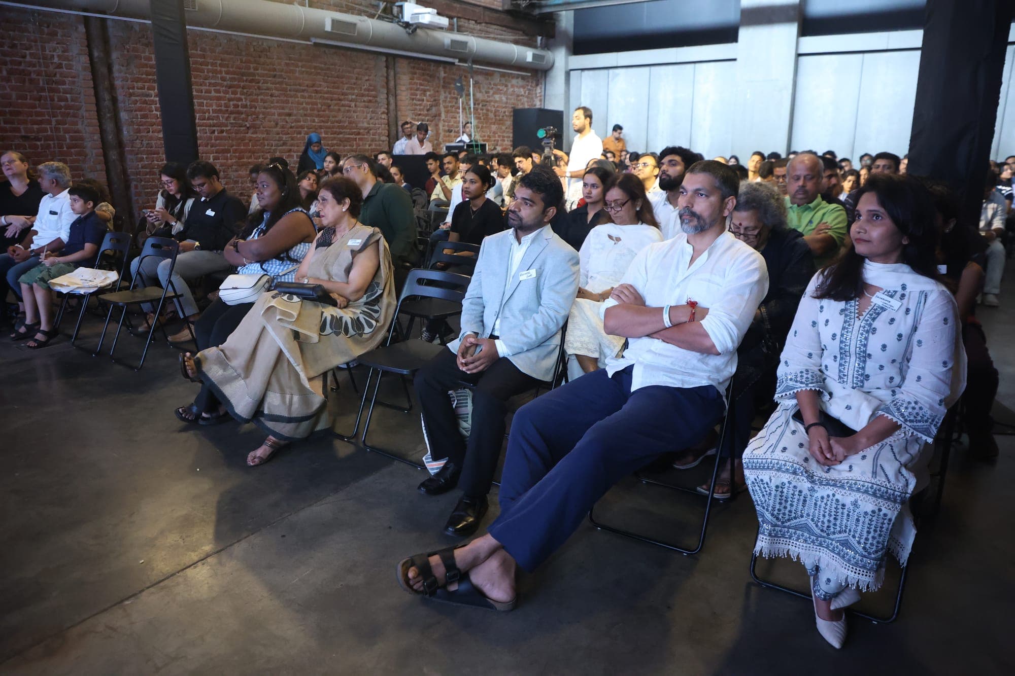 A wide view of the seated audience across several rows of the venue