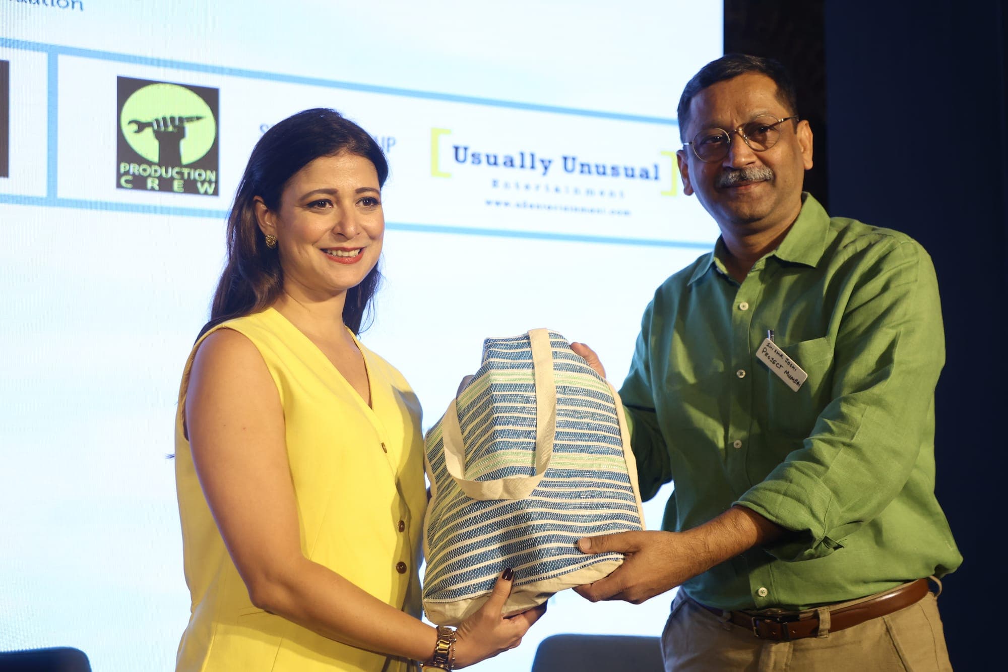 An ICUC Changemaker Award being handed over on stage