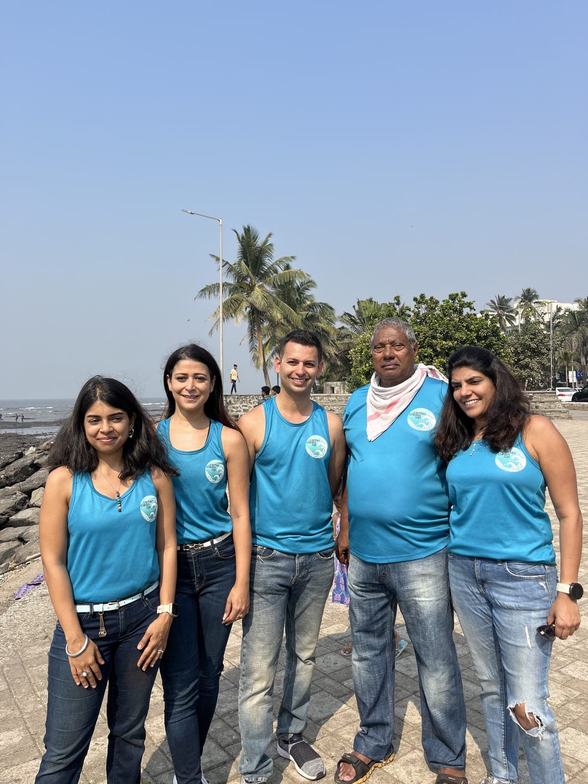 Five Carter Clean Up volunteers in branded t-shirts posing together on Carter Road